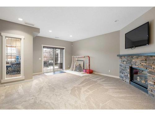 638 Coopers Drive Sw, Airdrie, AB - Indoor Photo Showing Living Room With Fireplace