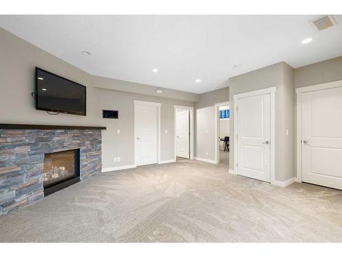 638 Coopers Drive Sw, Airdrie, AB - Indoor Photo Showing Living Room With Fireplace