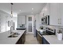 87 Waterford Manor, Chestermere, AB  - Indoor Photo Showing Kitchen With Double Sink With Upgraded Kitchen 