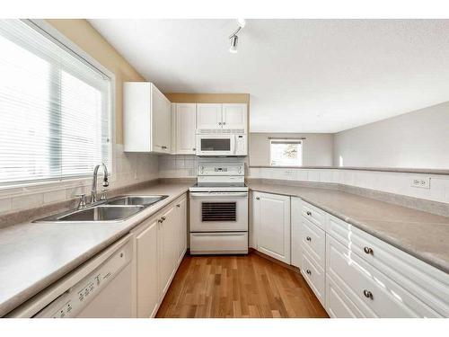 110-5500 Somervale Court Sw, Calgary, AB - Indoor Photo Showing Kitchen With Double Sink