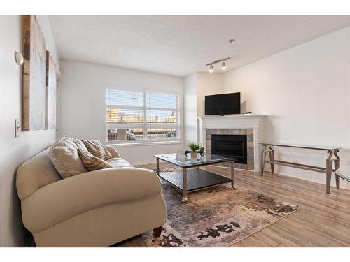 151-333 Riverfront Avenue Se, Calgary, AB - Indoor Photo Showing Living Room With Fireplace