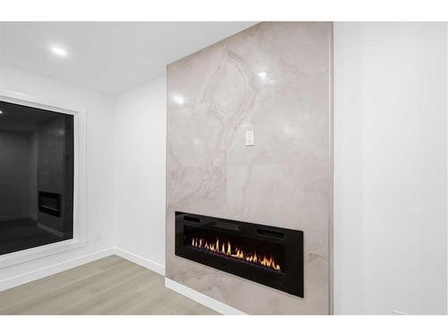 7915 Huntington Street Ne, Calgary, AB - Indoor Photo Showing Living Room With Fireplace