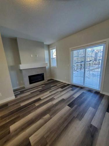 260 Copperleaf Way Se, Calgary, AB - Indoor Photo Showing Other Room With Fireplace