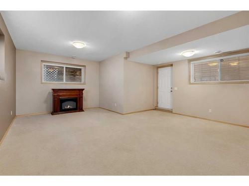 27 Covecreek Place Ne, Calgary, AB - Indoor Photo Showing Other Room With Fireplace