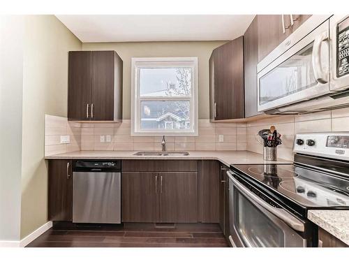 703-10 Auburn Bay Avenue Se, Calgary, AB - Indoor Photo Showing Kitchen With Stainless Steel Kitchen With Double Sink