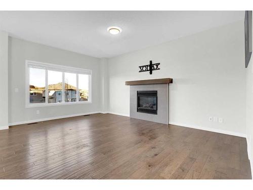 217 Hillcrest Drive Sw, Airdrie, AB - Indoor Photo Showing Living Room With Fireplace