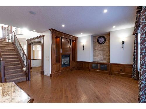 208 Coopers Grove Sw, Airdrie, AB - Indoor Photo Showing Other Room With Fireplace