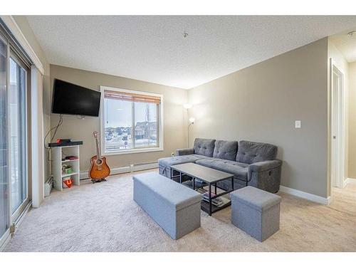 218-15 Saddlestone Way Ne, Calgary, AB - Indoor Photo Showing Living Room