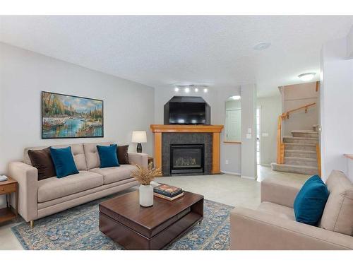 209 Douglas Glen Boulevard Se, Calgary, AB - Indoor Photo Showing Living Room With Fireplace