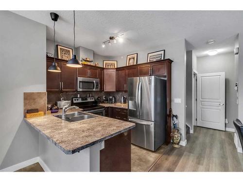 1007 Evanston Square Nw, Calgary, AB - Indoor Photo Showing Kitchen With Stainless Steel Kitchen With Double Sink With Upgraded Kitchen