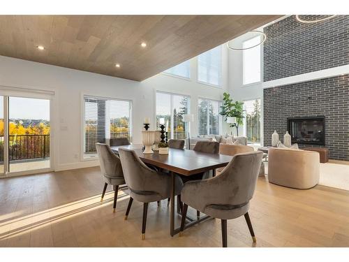 25 Timberline Court Sw, Calgary, AB - Indoor Photo Showing Dining Room With Fireplace