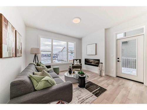 100 Wolf Hollow Villas Se, Calgary, AB - Indoor Photo Showing Living Room With Fireplace