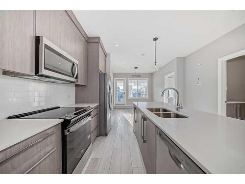 1315-111 Wolf Creek Drive Se, Calgary, AB - Indoor Photo Showing Kitchen With Double Sink With Upgraded Kitchen