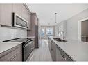 1315-111 Wolf Creek Drive Se, Calgary, AB  - Indoor Photo Showing Kitchen With Double Sink With Upgraded Kitchen 