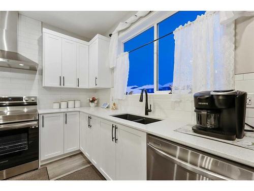 84 Wolf Gate, Okotoks, AB - Indoor Photo Showing Kitchen With Double Sink