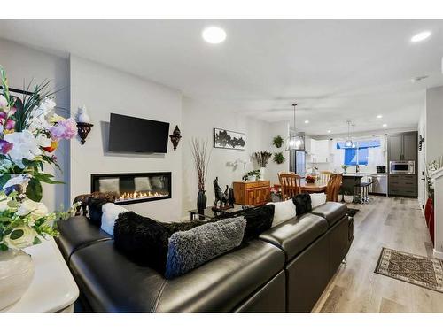 84 Wolf Gate, Okotoks, AB - Indoor Photo Showing Living Room With Fireplace