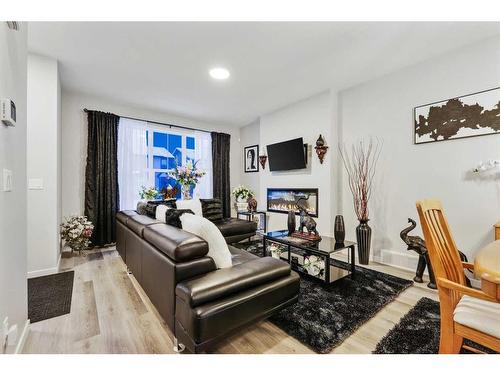 84 Wolf Gate, Okotoks, AB - Indoor Photo Showing Living Room With Fireplace