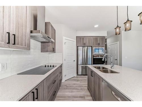 58 Cobbleridge Place Sw, Airdrie, AB - Indoor Photo Showing Kitchen With Double Sink With Upgraded Kitchen