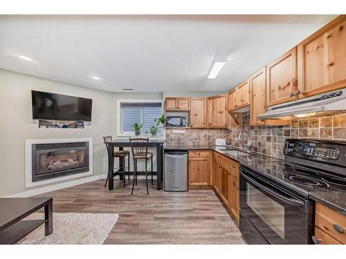 960 Wilson Way, Canmore, AB - Indoor Photo Showing Kitchen With Fireplace