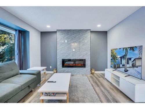 9 Sunvale Crescent Se, Calgary, AB - Indoor Photo Showing Living Room With Fireplace