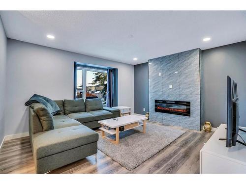 9 Sunvale Crescent Se, Calgary, AB - Indoor Photo Showing Living Room With Fireplace