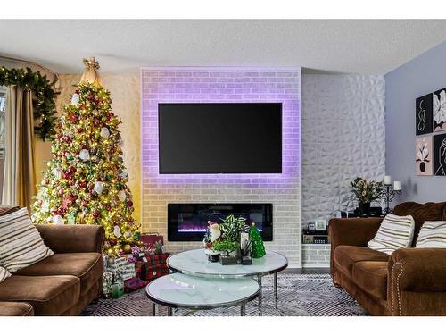 214 Evansmeade Point Nw, Calgary, AB - Indoor Photo Showing Living Room With Fireplace