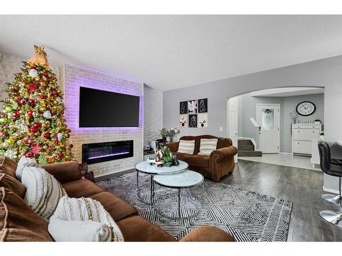 214 Evansmeade Point Nw, Calgary, AB - Indoor Photo Showing Living Room With Fireplace