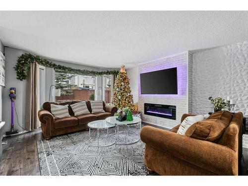 214 Evansmeade Point Nw, Calgary, AB - Indoor Photo Showing Living Room With Fireplace