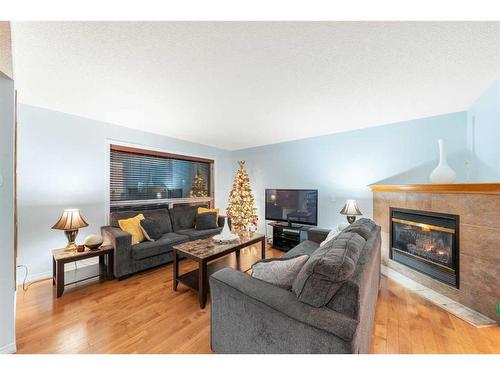 153 Somerset Way Sw, Calgary, AB - Indoor Photo Showing Living Room With Fireplace