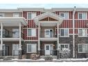 52 West Coach Manor Sw, Calgary, AB  - Outdoor With Balcony With Facade 