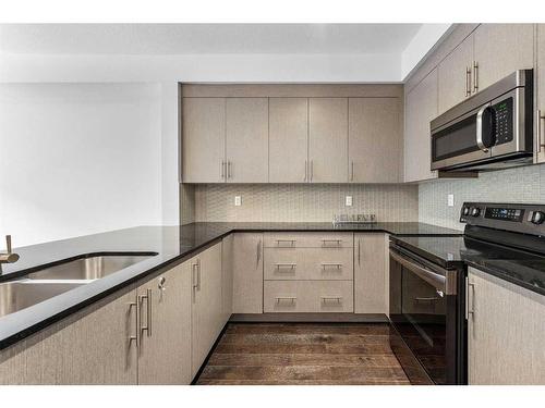 52 West Coach Manor Sw, Calgary, AB - Indoor Photo Showing Kitchen With Stainless Steel Kitchen With Double Sink With Upgraded Kitchen