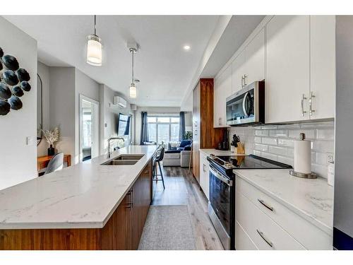 305-1702 17 Avenue Sw, Calgary, AB - Indoor Photo Showing Kitchen With Double Sink With Upgraded Kitchen