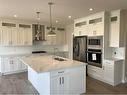 729 Mandalay Avenue Nw, Carstairs, AB  - Indoor Photo Showing Kitchen With Double Sink With Upgraded Kitchen 