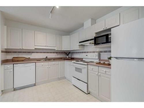 1301-1000 Sienna Park Green Sw, Calgary, AB - Indoor Photo Showing Kitchen With Double Sink