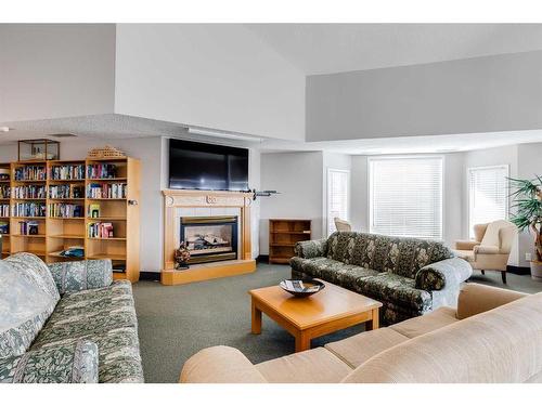 1301-1000 Sienna Park Green Sw, Calgary, AB - Indoor Photo Showing Living Room With Fireplace