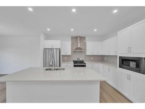 305 Baneberry Way Sw, Airdrie, AB - Indoor Photo Showing Kitchen With Stainless Steel Kitchen With Double Sink With Upgraded Kitchen