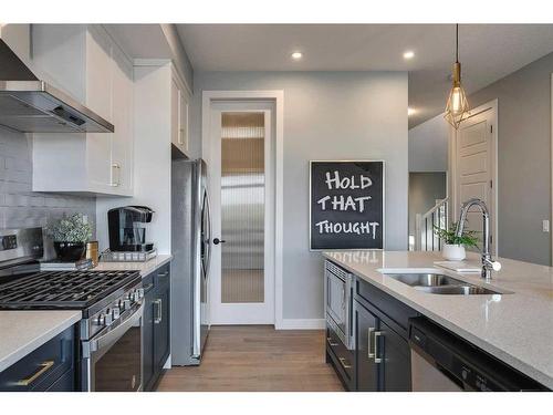 91 Sundown Crescent, Cochrane, AB - Indoor Photo Showing Kitchen With Double Sink With Upgraded Kitchen