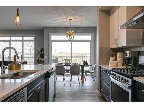 91 Sundown Crescent, Cochrane, AB - Indoor Photo Showing Kitchen With Double Sink With Upgraded Kitchen