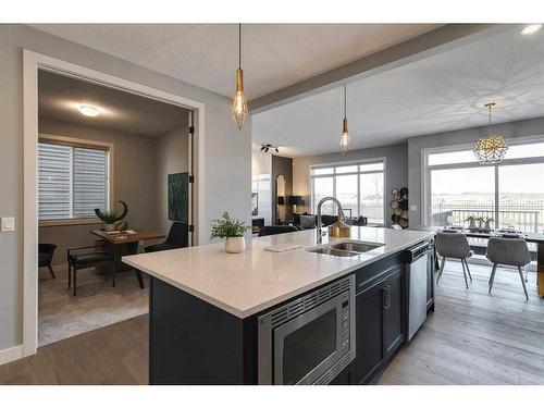 91 Sundown Crescent, Cochrane, AB - Indoor Photo Showing Kitchen With Double Sink