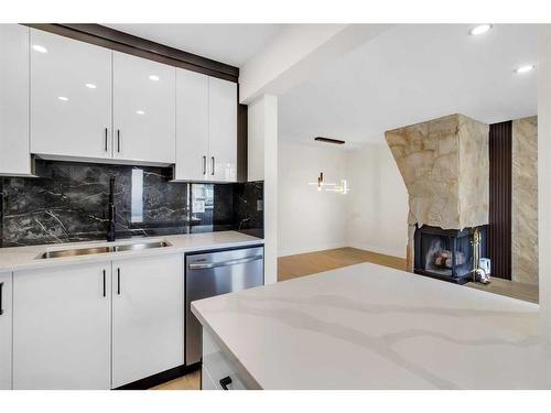 61-116 Silver Crest Drive Nw, Calgary, AB - Indoor Photo Showing Kitchen With Fireplace With Double Sink