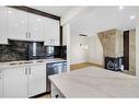 61-116 Silver Crest Drive Nw, Calgary, AB  - Indoor Photo Showing Kitchen With Fireplace With Double Sink 