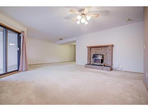 72 Sandarac Circle Nw, Calgary, AB - Indoor Photo Showing Living Room With Fireplace