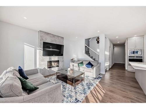 760 Corner Meadows Way Ne, Calgary, AB - Indoor Photo Showing Living Room With Fireplace