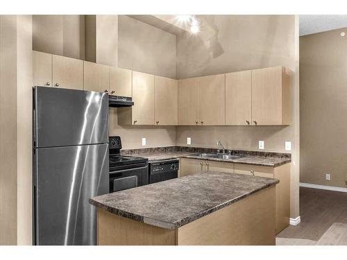 211-1111 6 Avenue Sw, Calgary, AB - Indoor Photo Showing Kitchen With Double Sink