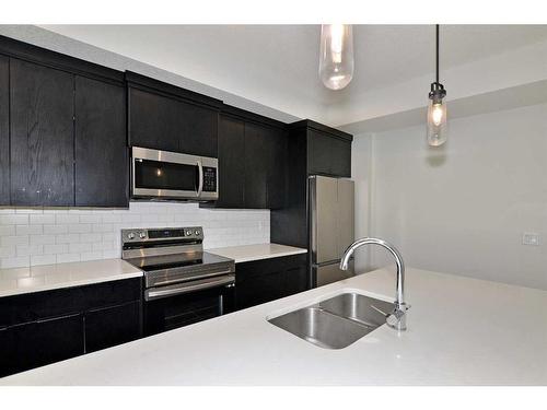 2206-220 Seton Grove Se, Calgary, AB - Indoor Photo Showing Kitchen With Stainless Steel Kitchen With Double Sink