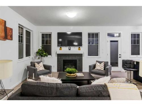 901 Windsong Drive Sw, Airdrie, AB - Indoor Photo Showing Living Room With Fireplace