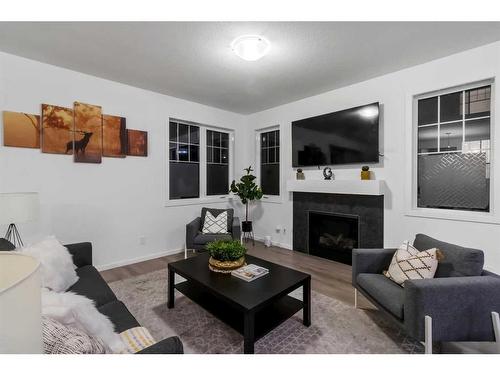 901 Windsong Drive Sw, Airdrie, AB - Indoor Photo Showing Living Room With Fireplace