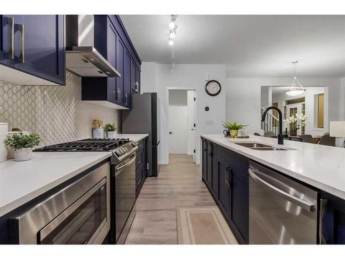 901 Windsong Drive Sw, Airdrie, AB - Indoor Photo Showing Kitchen With Stainless Steel Kitchen With Double Sink With Upgraded Kitchen