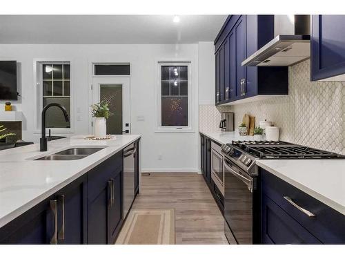 901 Windsong Drive Sw, Airdrie, AB - Indoor Photo Showing Kitchen With Double Sink With Upgraded Kitchen