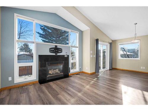 1721 Harrison Street, Crossfield, AB - Indoor Photo Showing Living Room With Fireplace